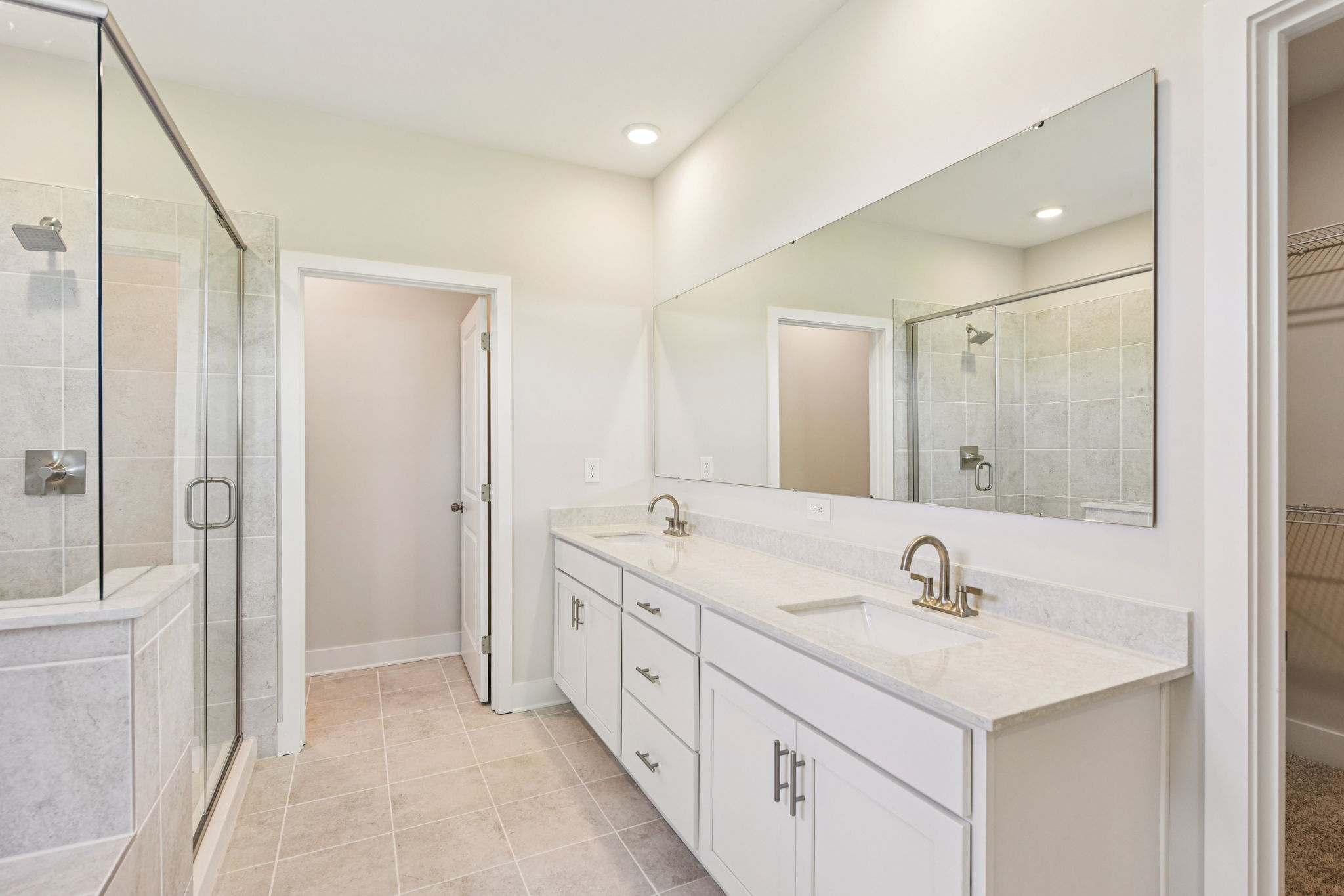 A bathroom with a large mirror.