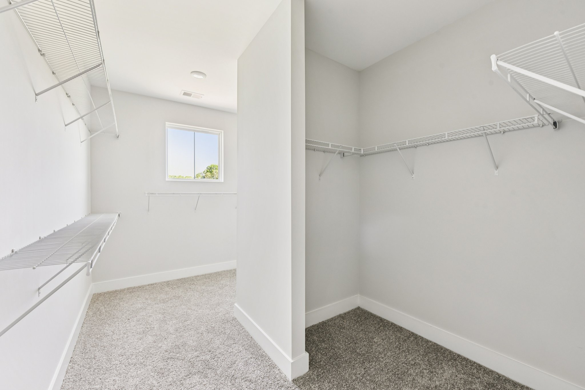 A white room with a window.