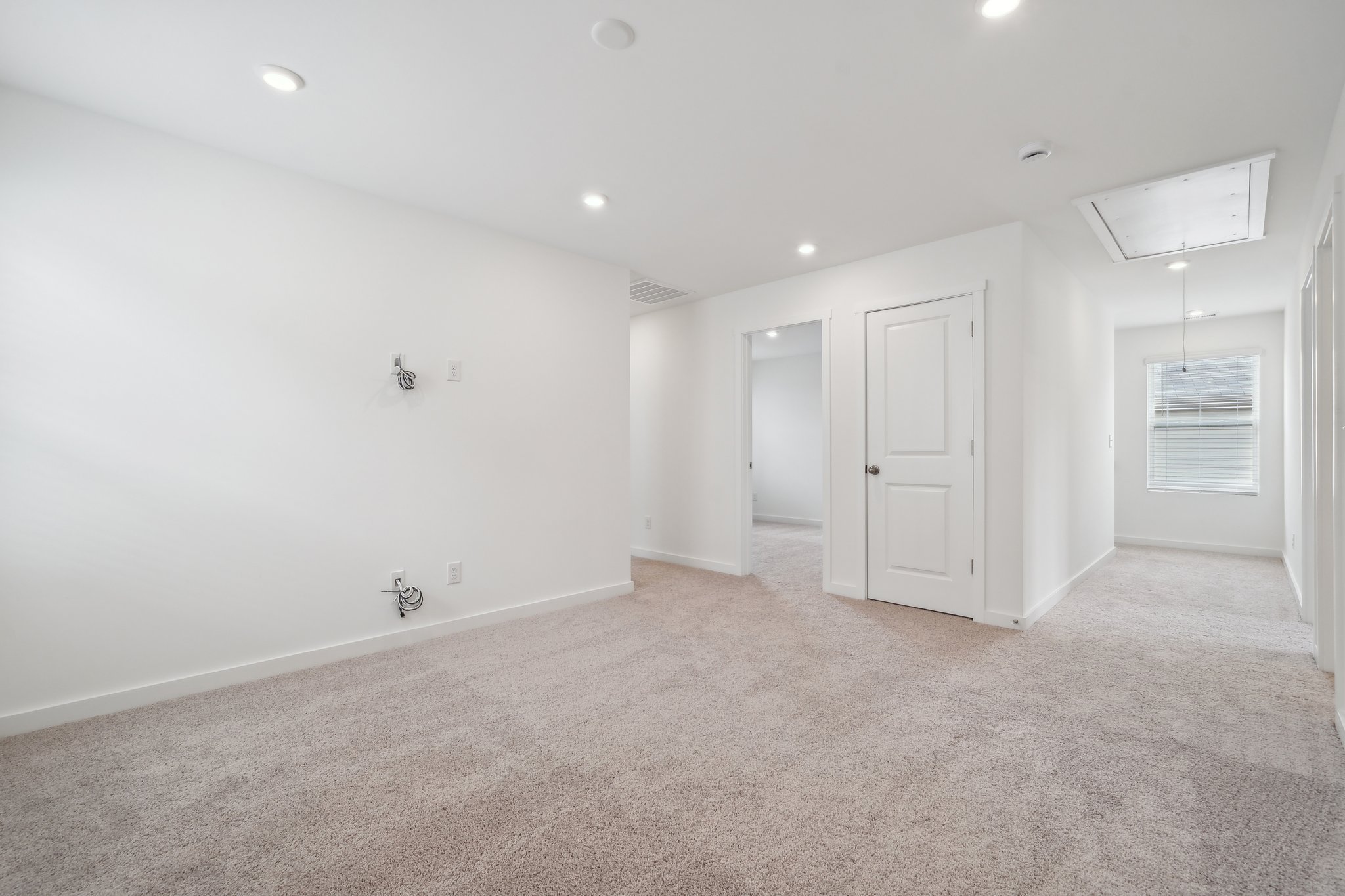 A room with white walls and a carpeted floor.