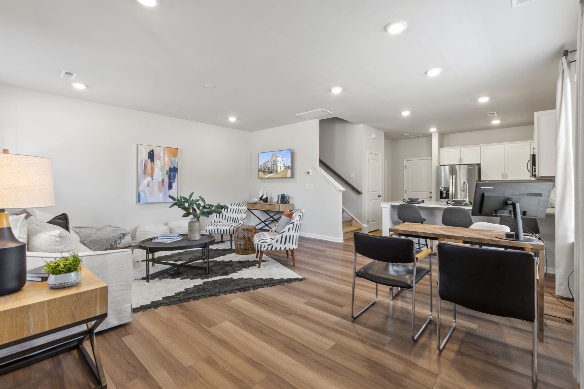 A large living room with a wood floor.