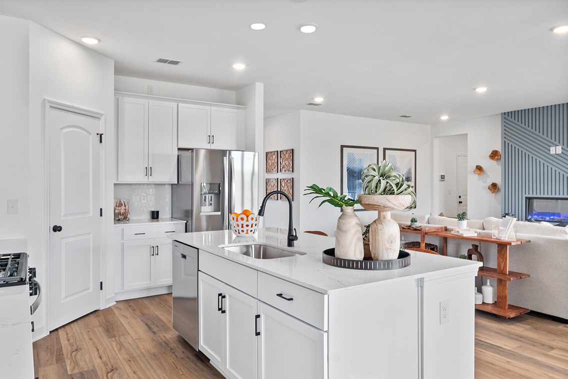 A kitchen with white cabinets.