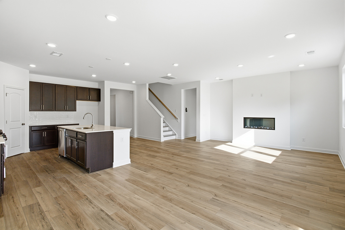 A large kitchen with wood floors.