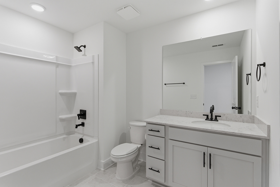 A bathroom with a tub toilet and sink.