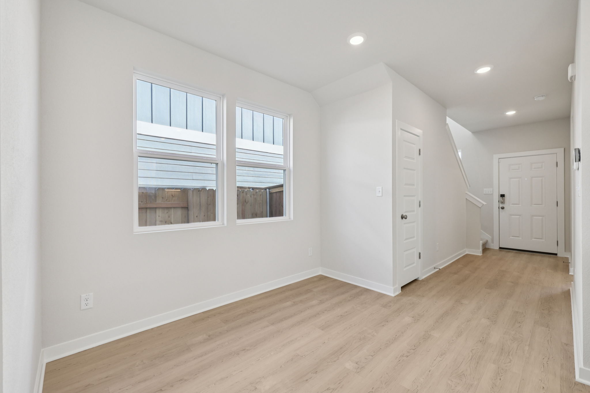 A room with white walls and a wood floor.