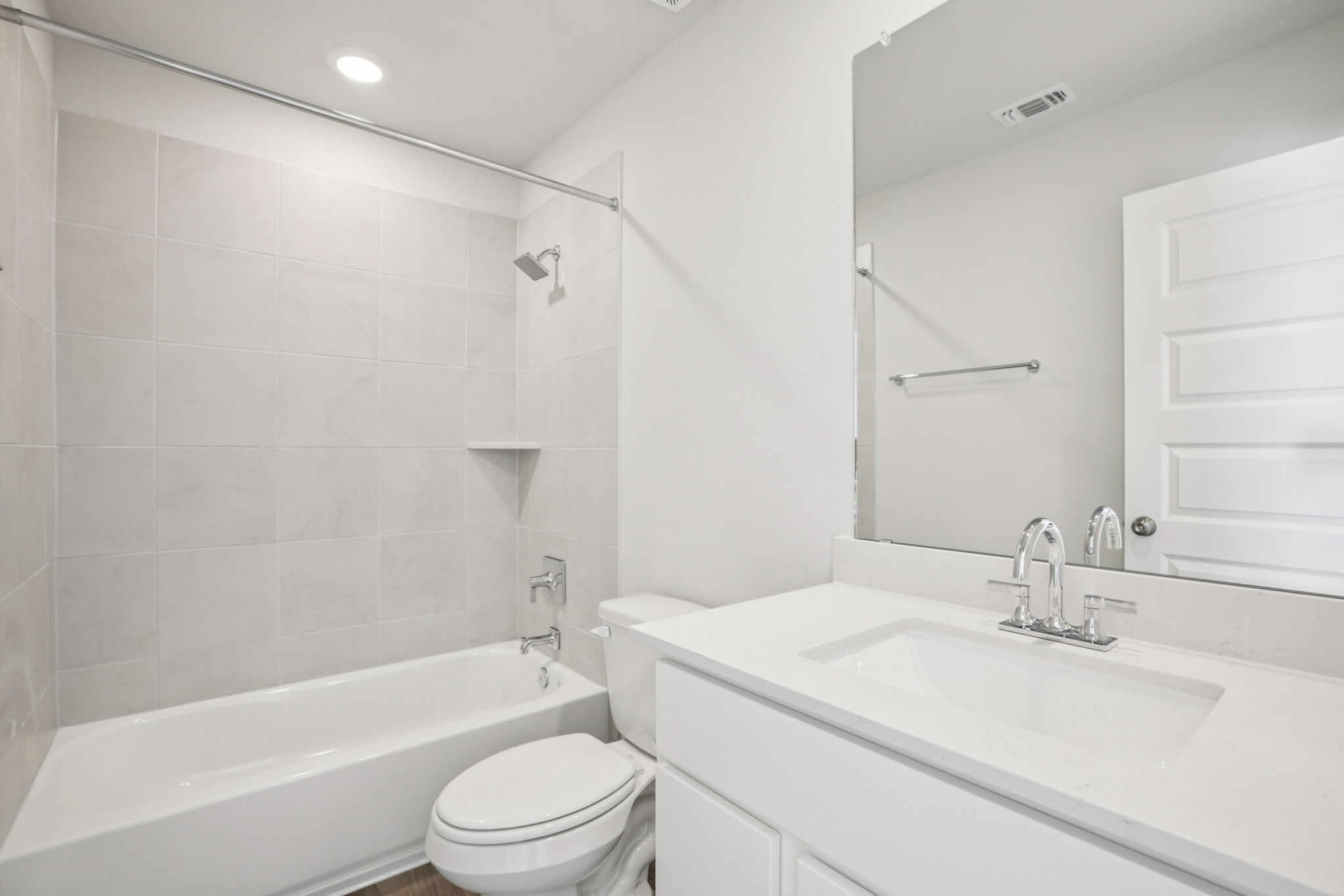 A bathroom with a tub sink and toilet.