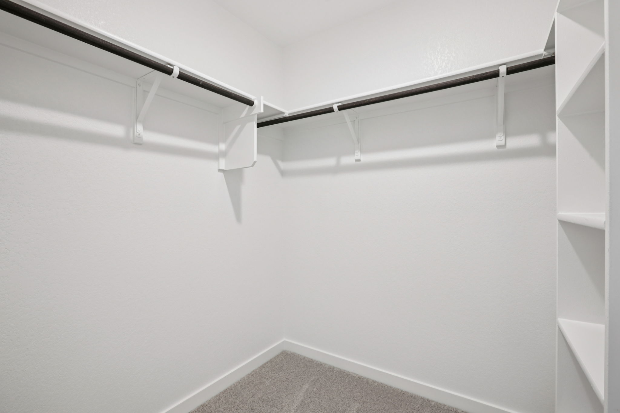 A white wall with a metal railing.