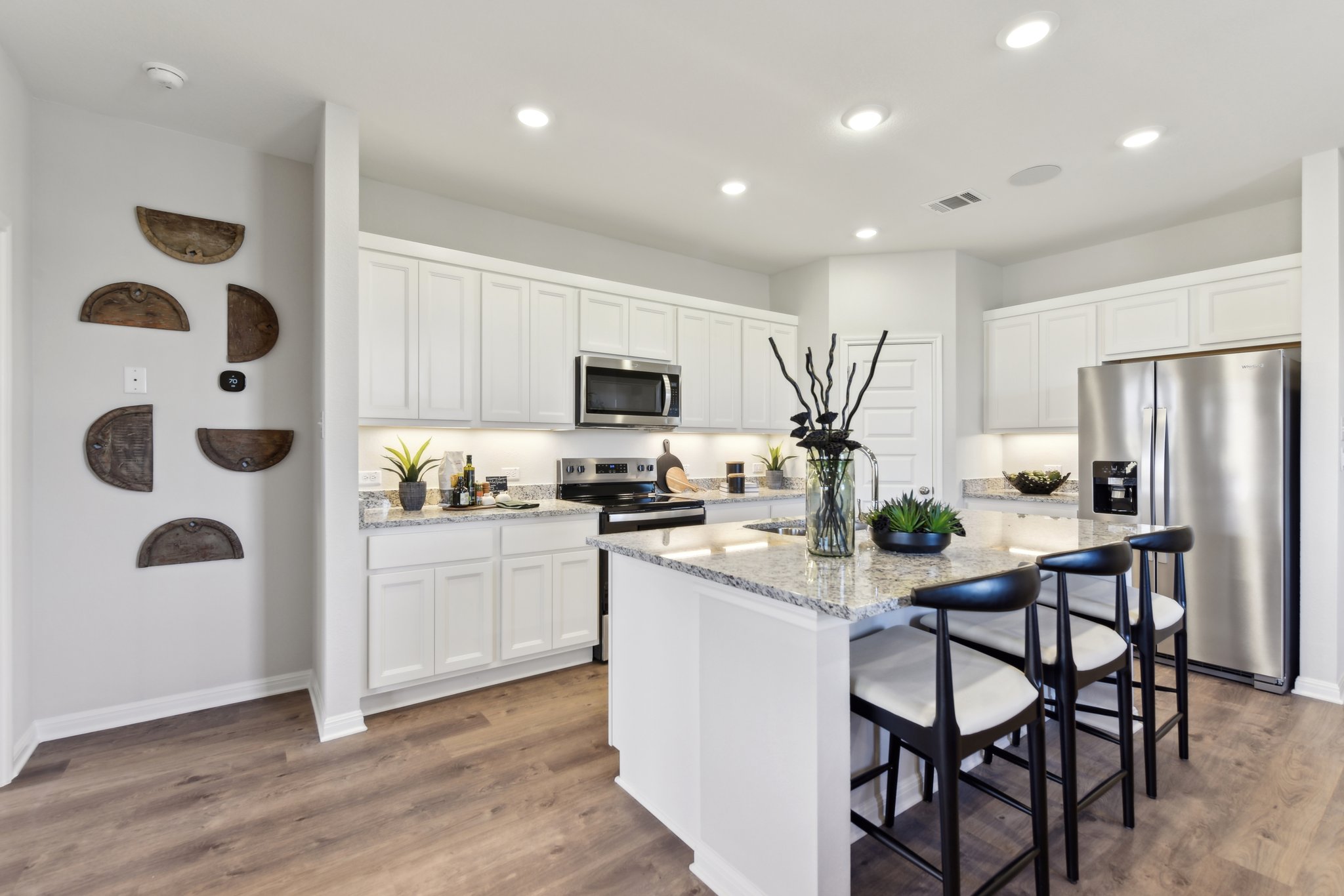 A kitchen with white cabinets.