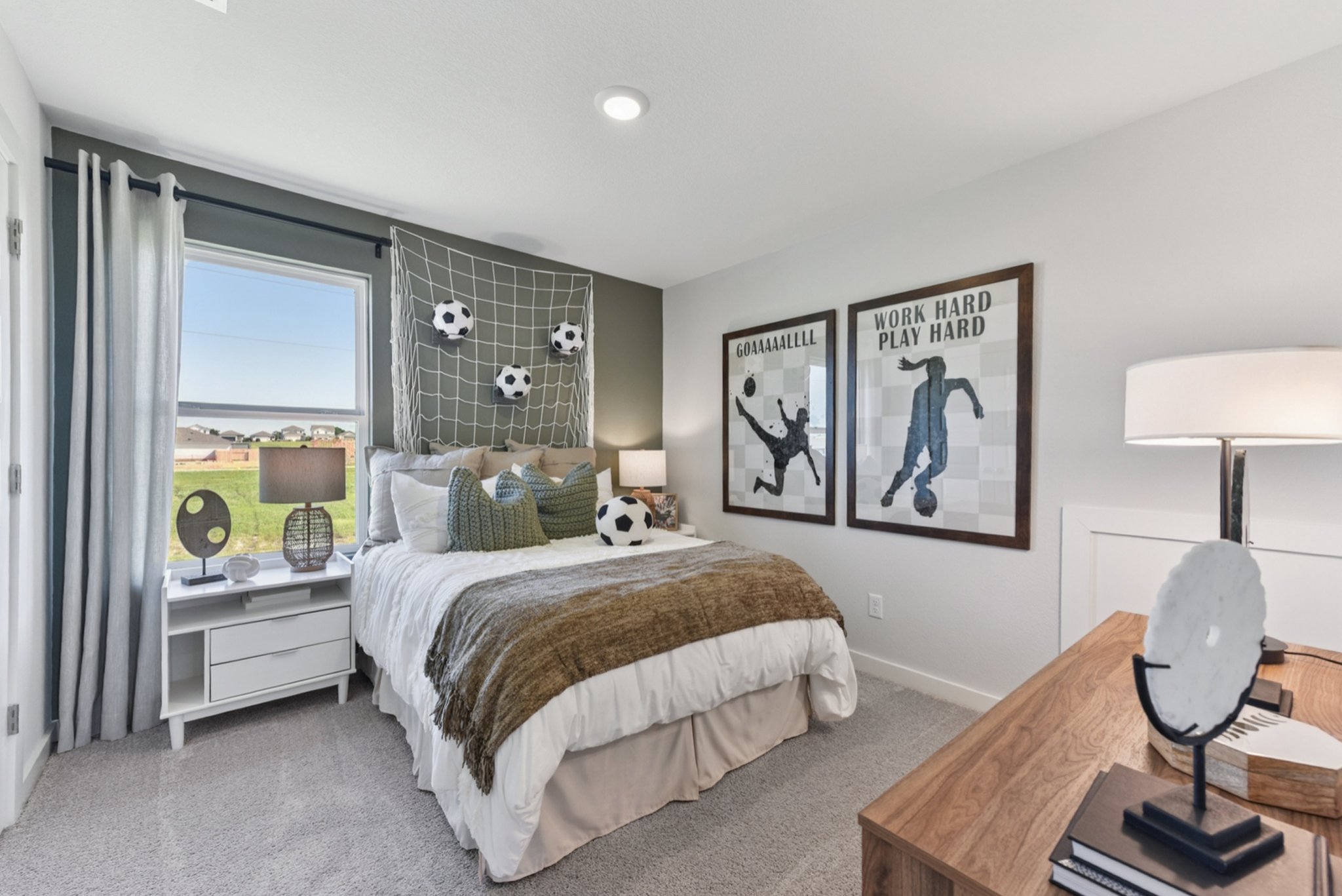 A bedroom with a bed and a desk.