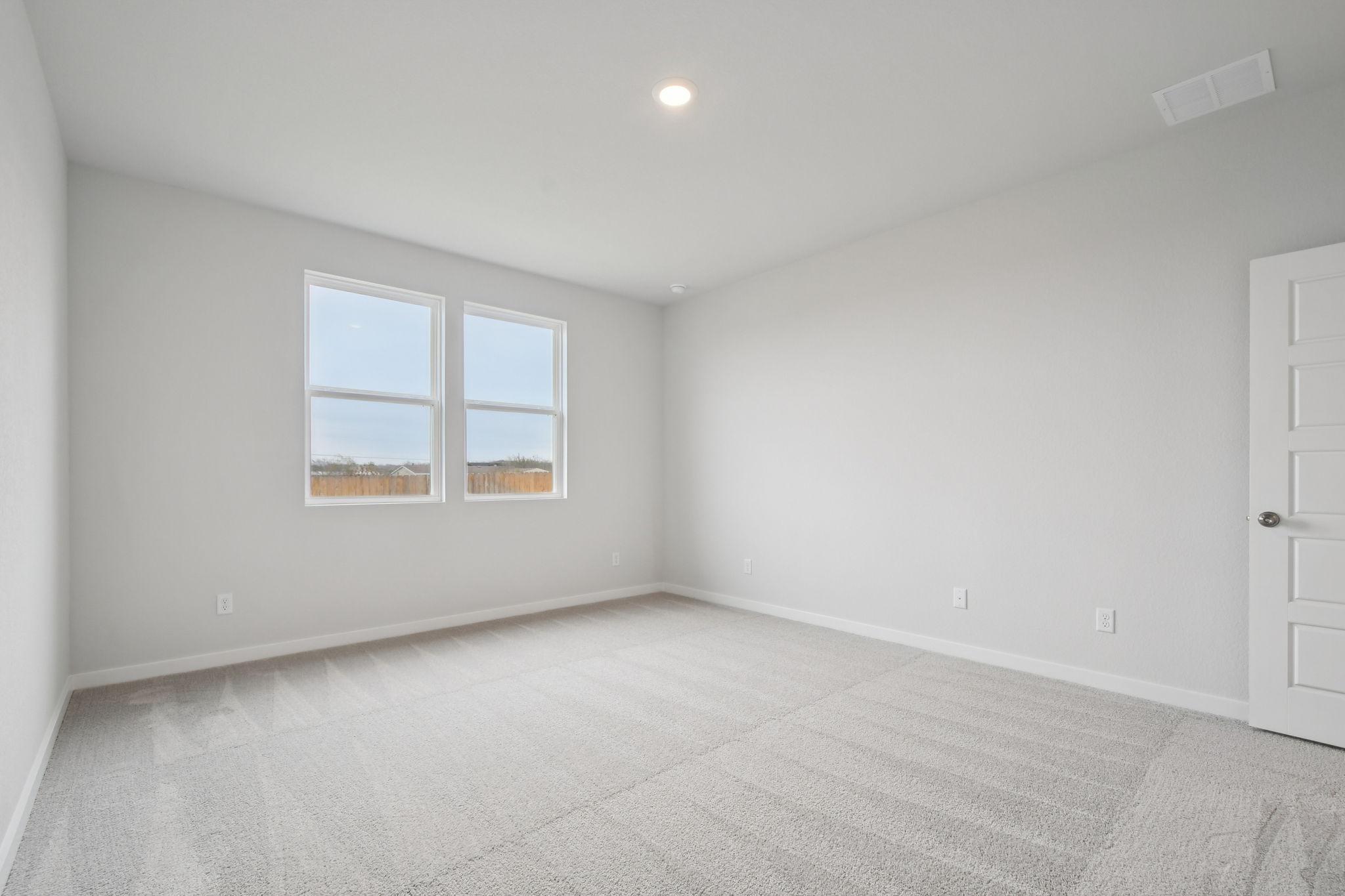 A room with a window and a door.