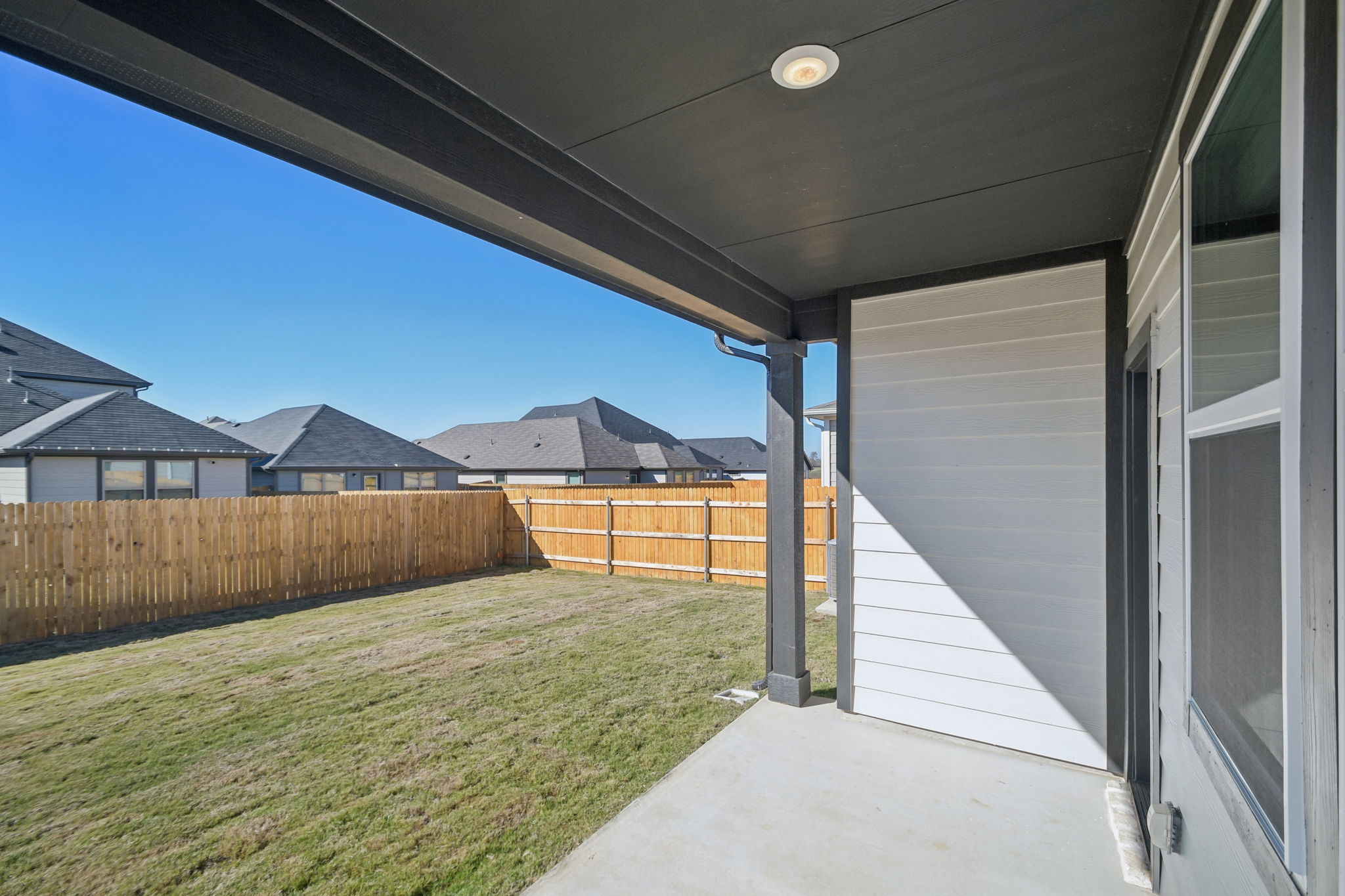 A house with a fence and grass.