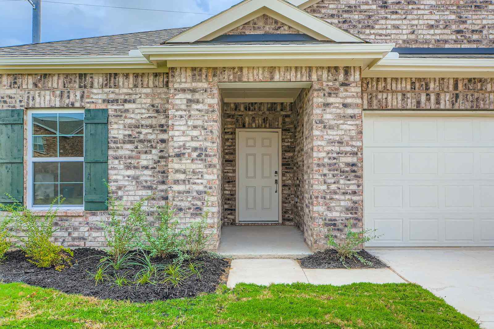 A house with a garage and a door.
