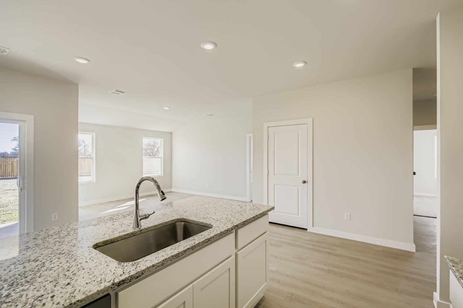 A kitchen with marble counters.