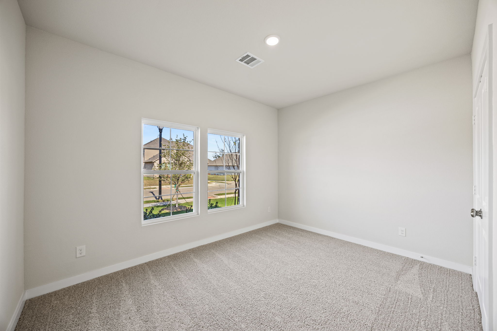 A room with a window and a door.