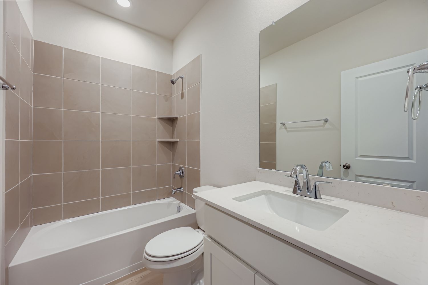 A bathroom with a tub sink and toilet.