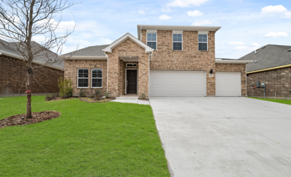 A brick house with a driveway.
