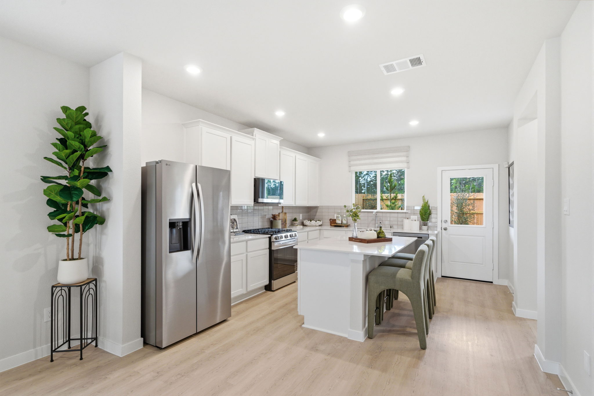 A kitchen with white cabinets.