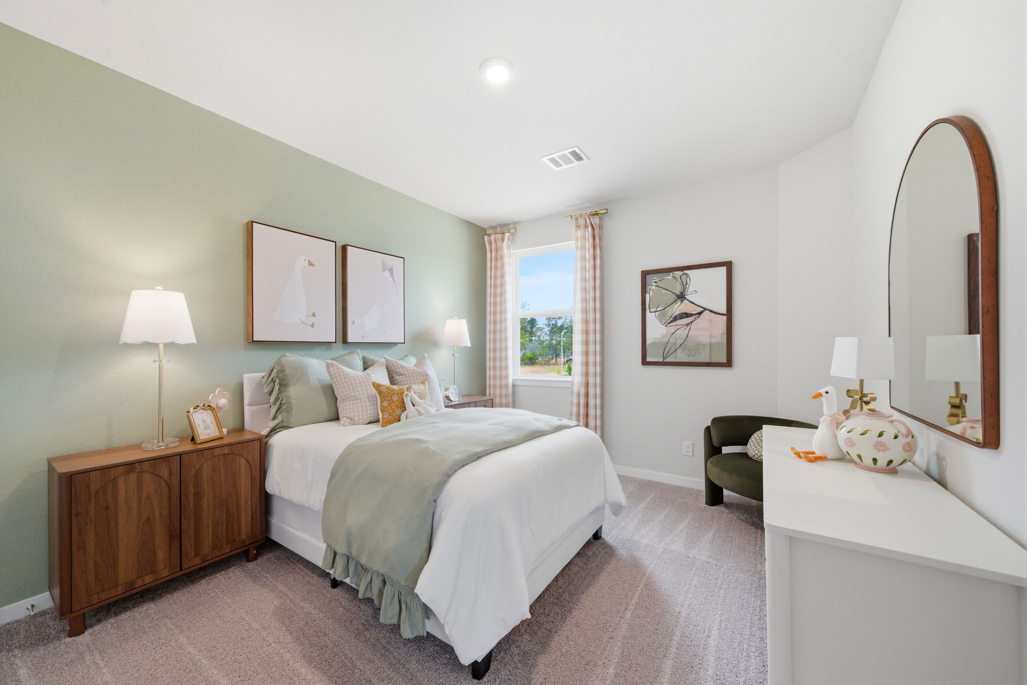 A bedroom with a bed and a mirror.