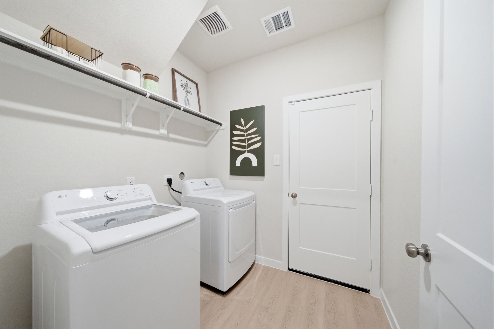 A laundry room with white walls.