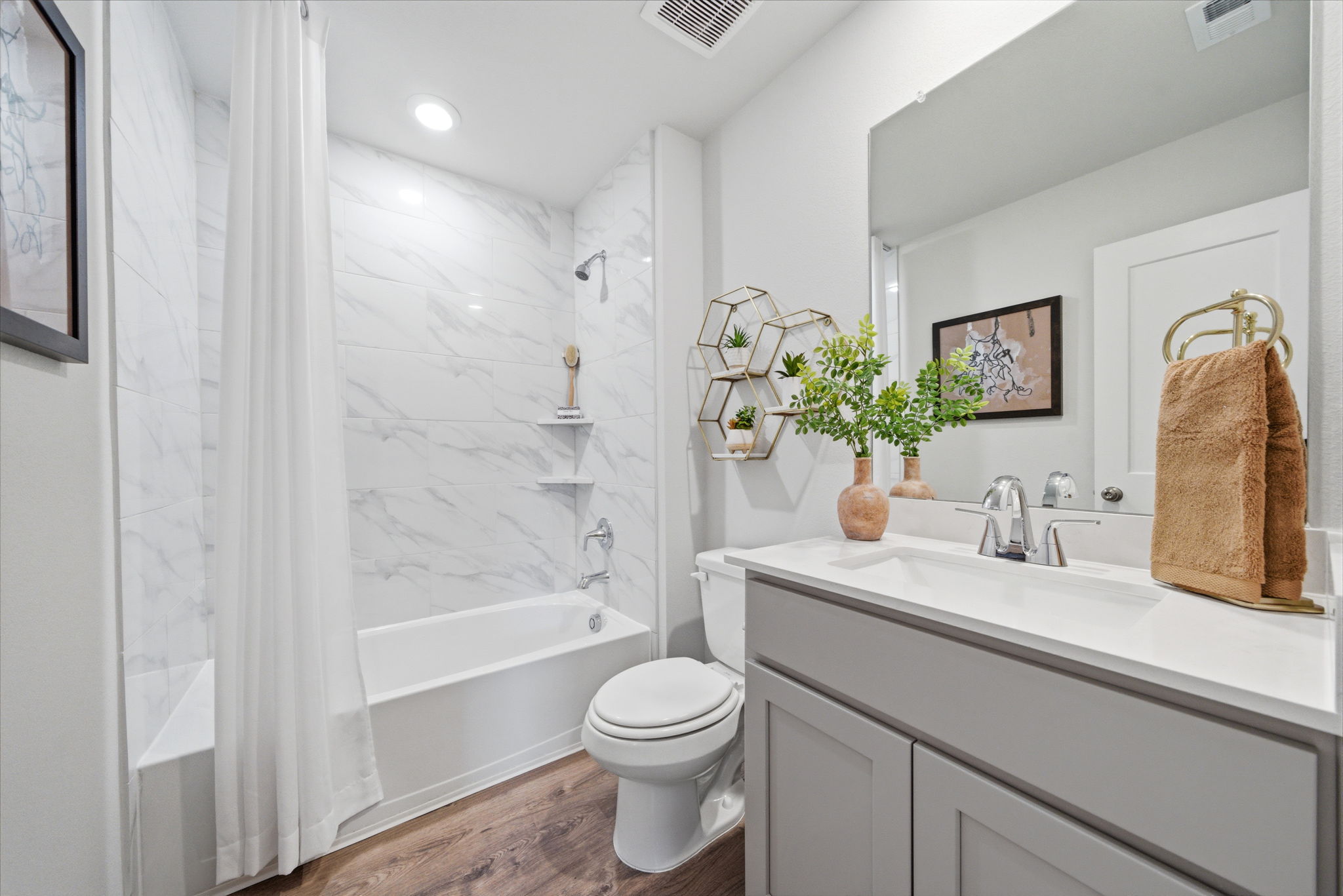 A bathroom with a tub toilet and sink.