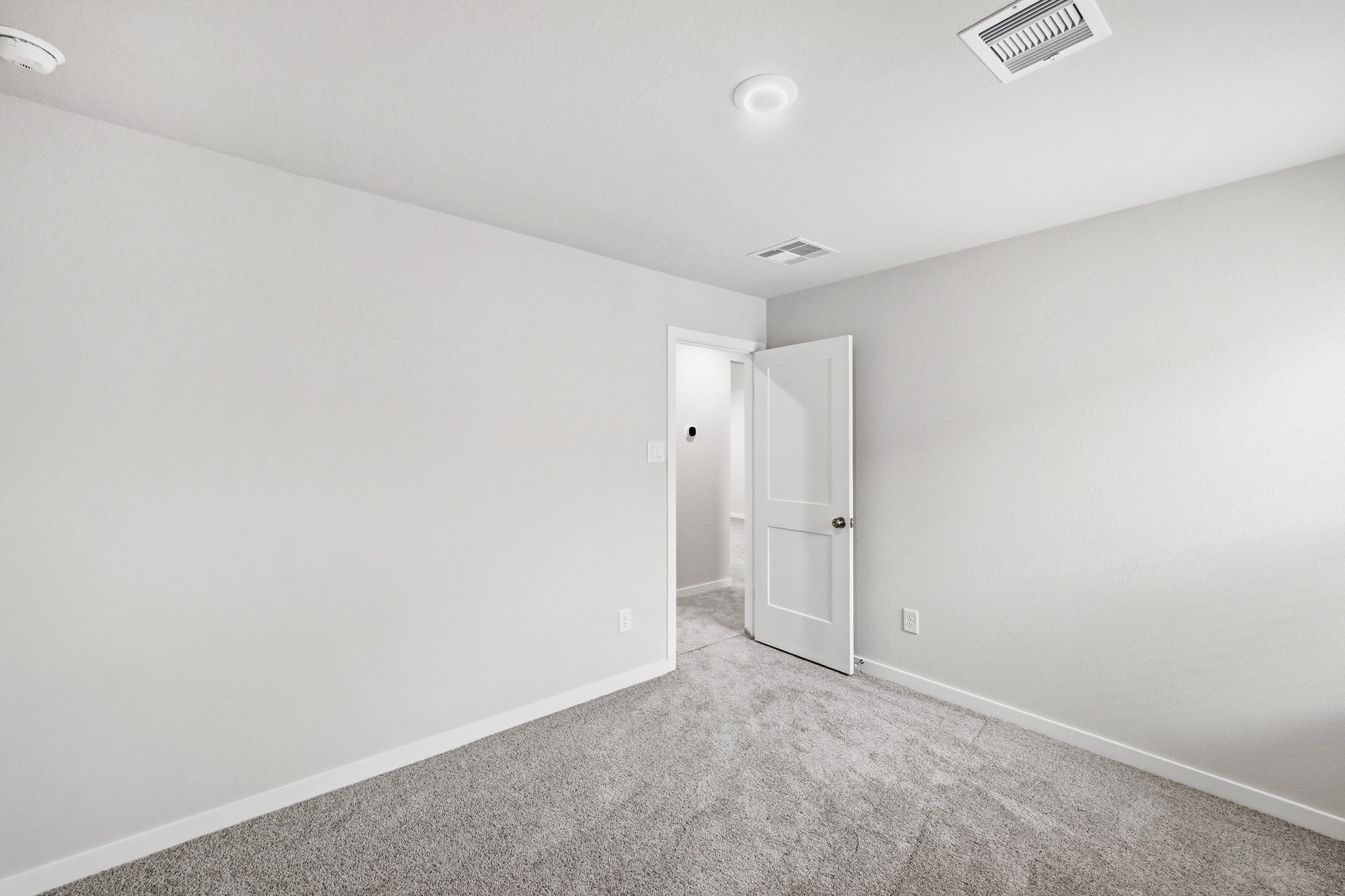 A hallway with white walls.