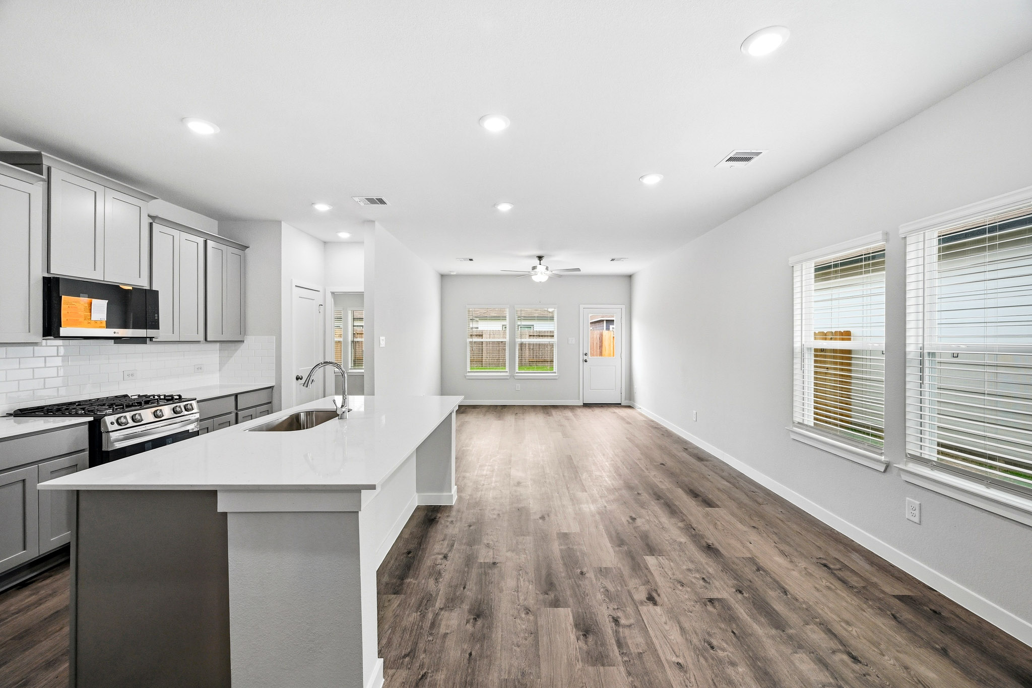 A kitchen with white cabinets.