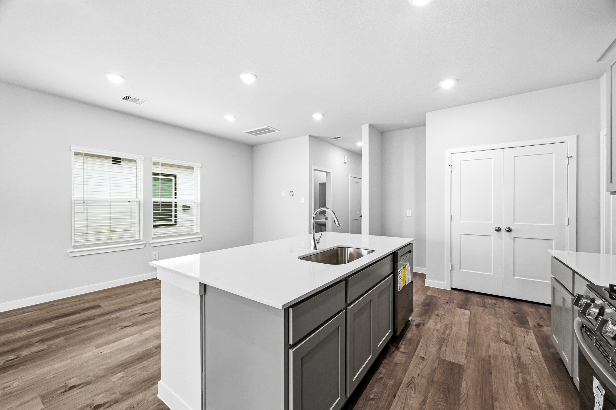 A kitchen with white cabinets.