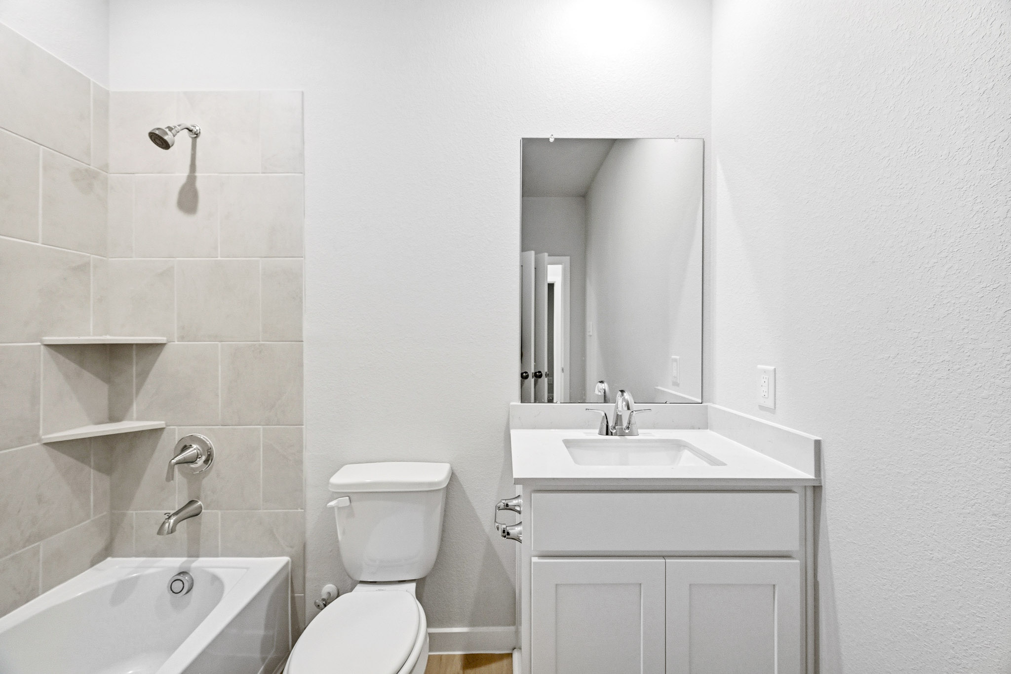 A bathroom with a tub sink and toilet.