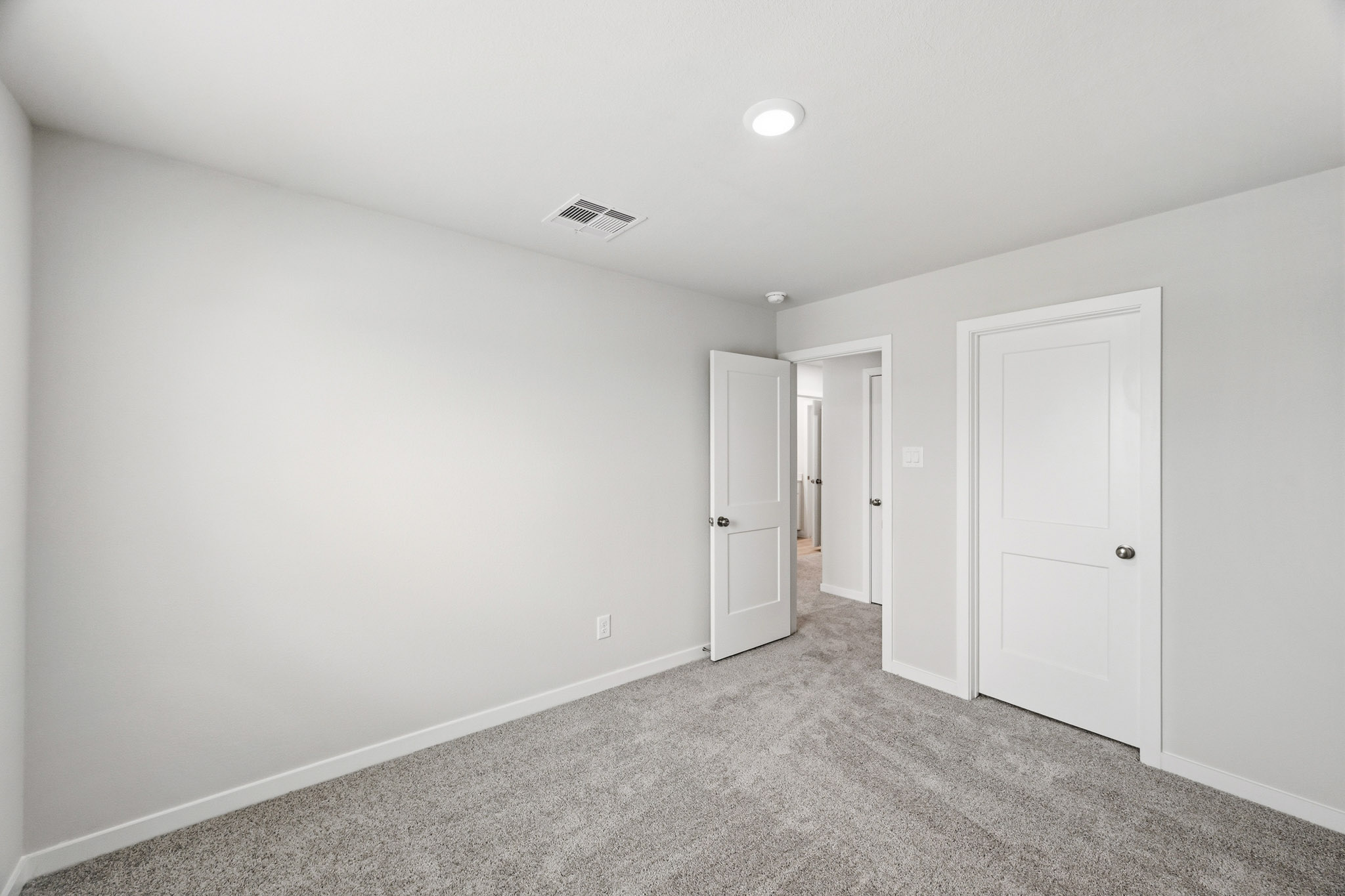 A hallway with white doors.