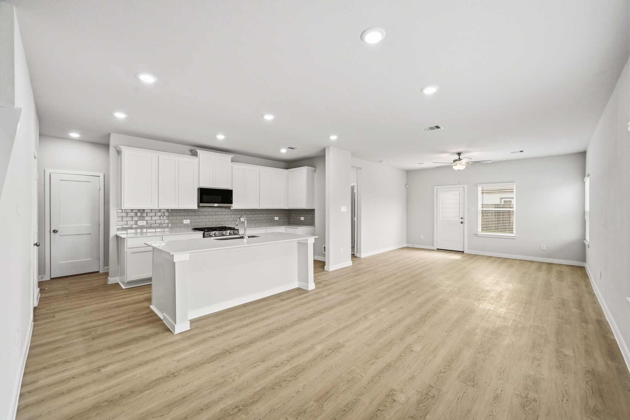 A large kitchen with white cabinets.