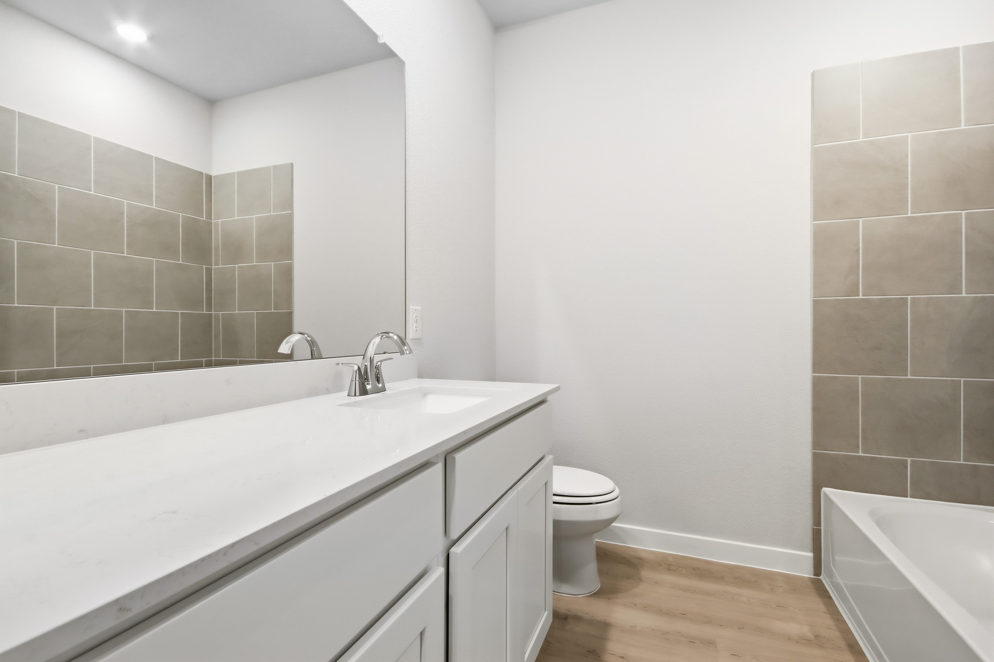 A bathroom with a tub sink and toilet.