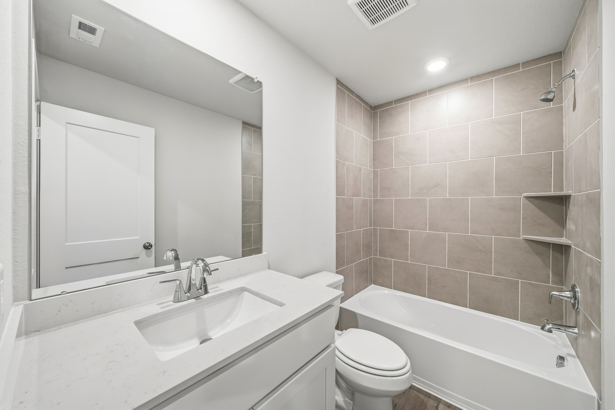 A bathroom with a tub sink and toilet.