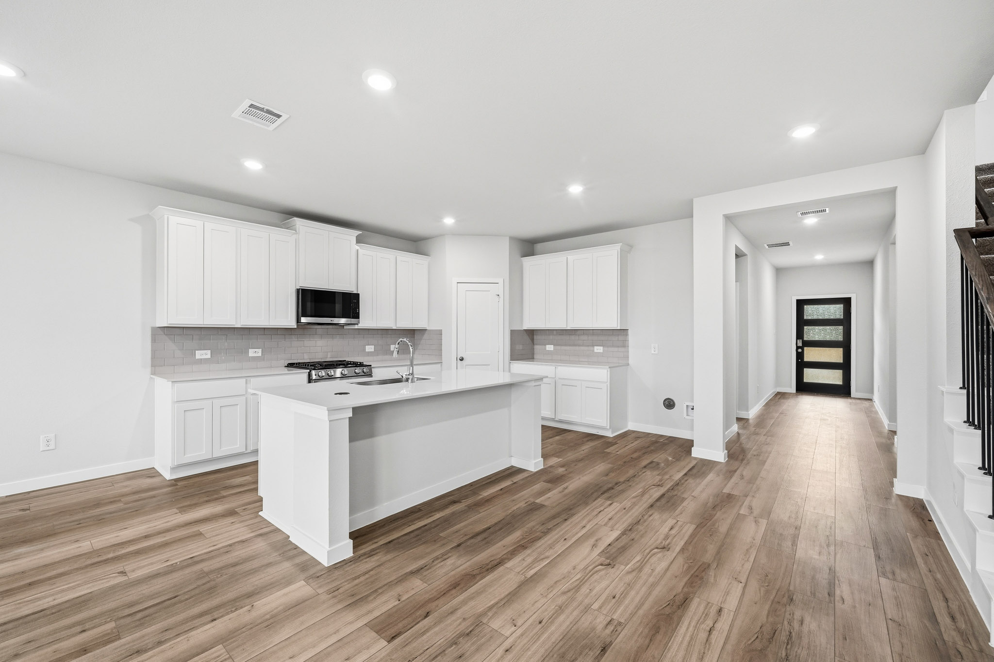 A kitchen with white cabinets.