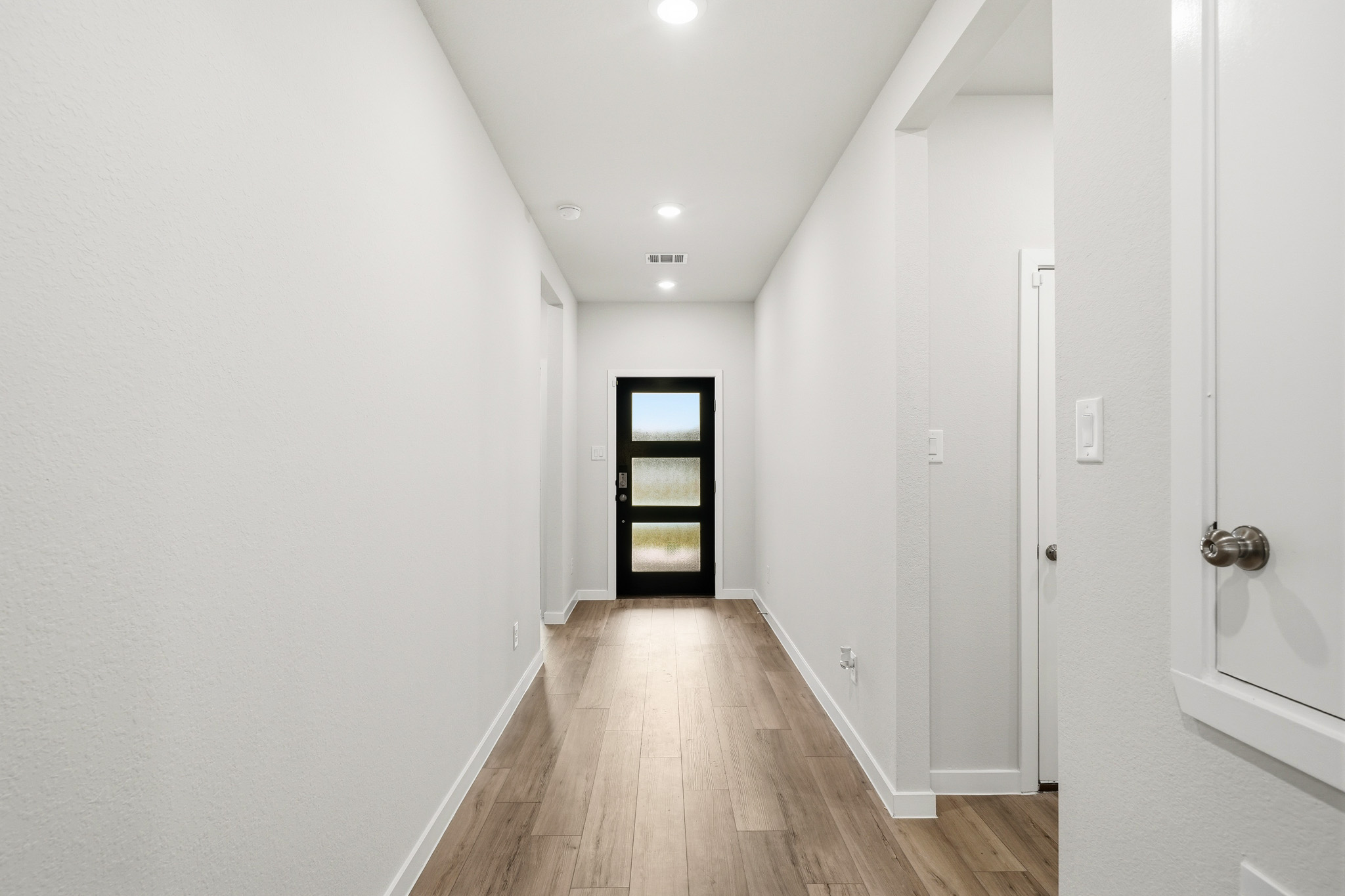 A hallway with white walls.