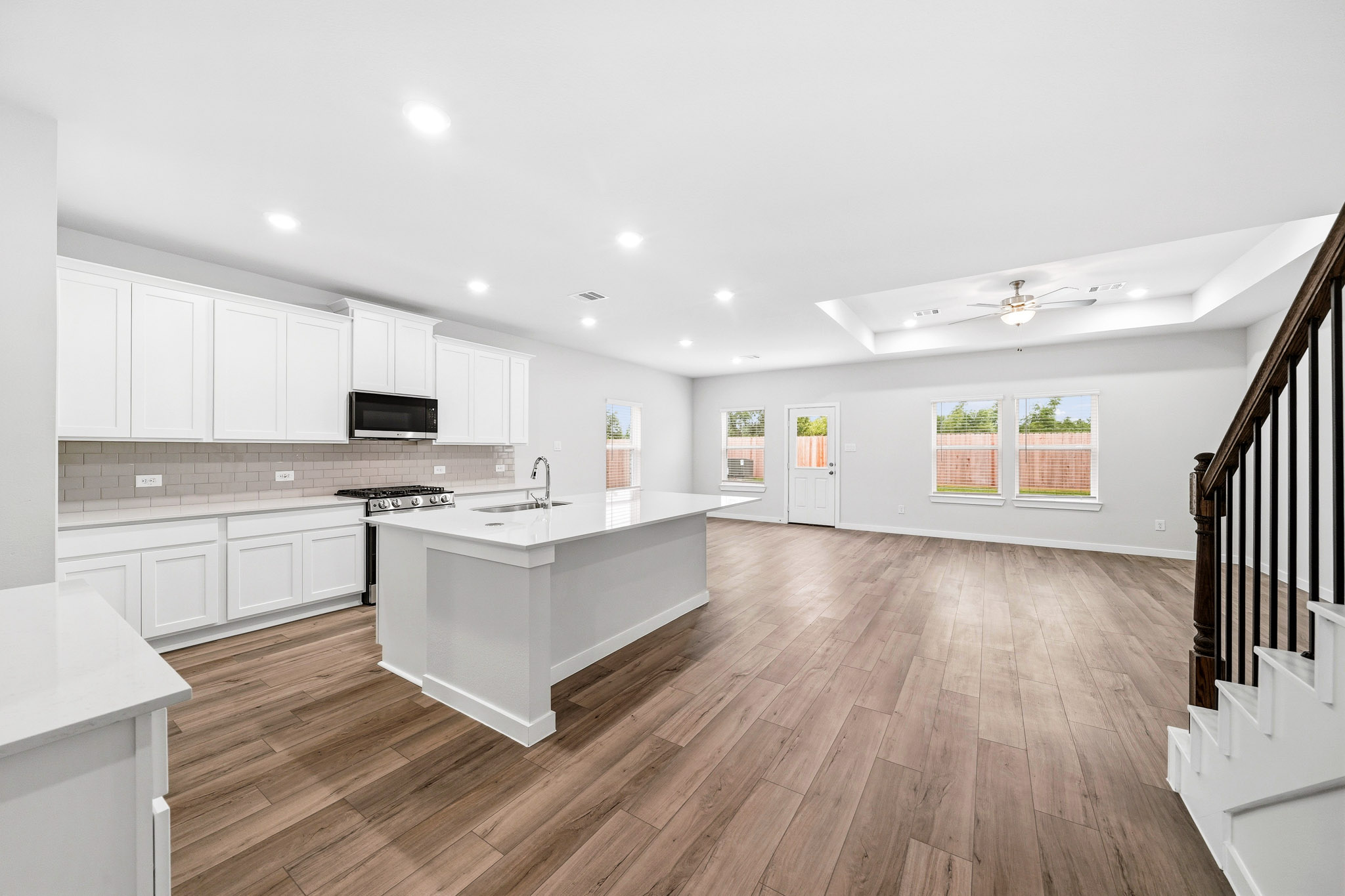 A kitchen with white cabinets.