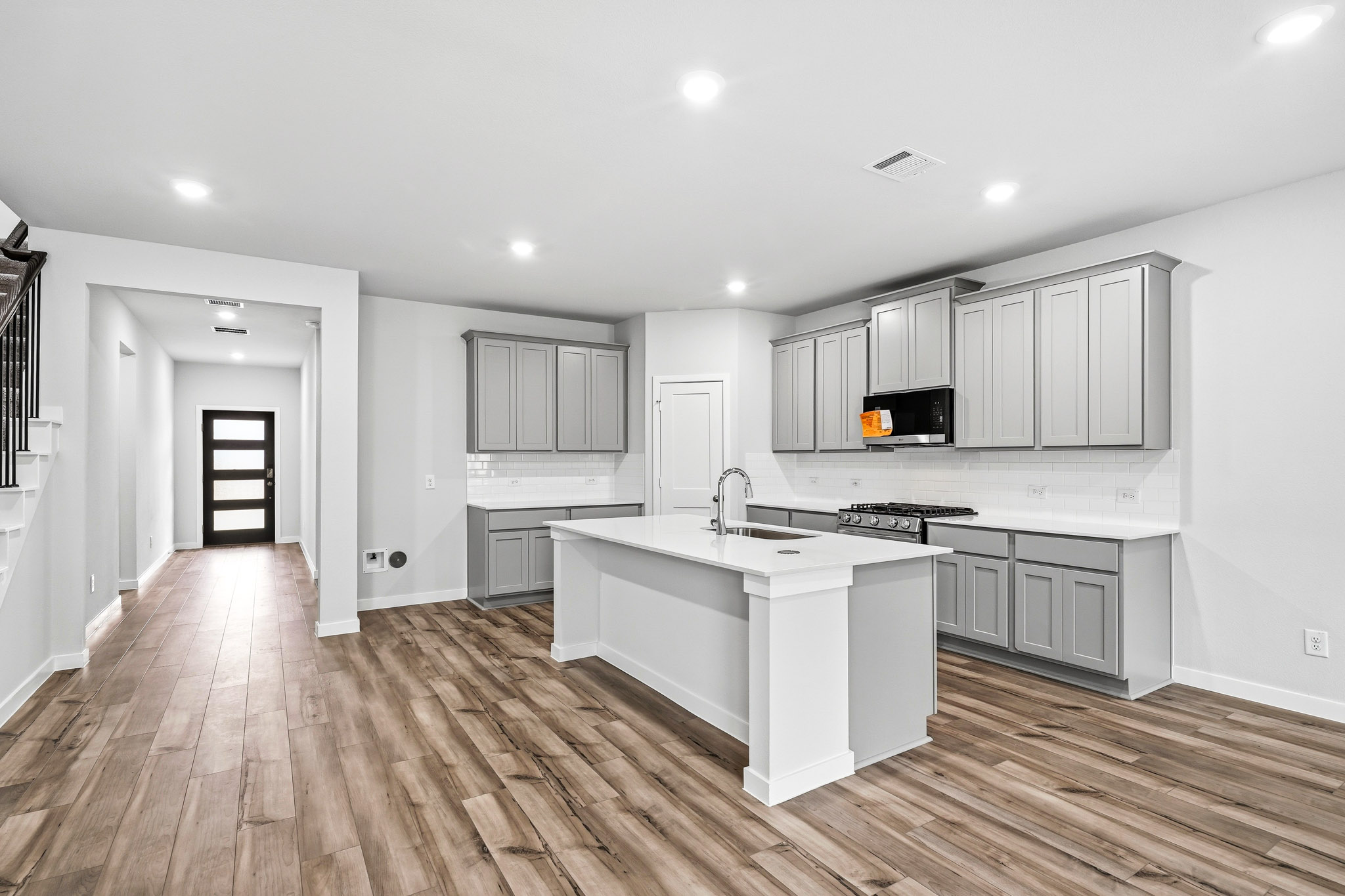A kitchen with white cabinets.