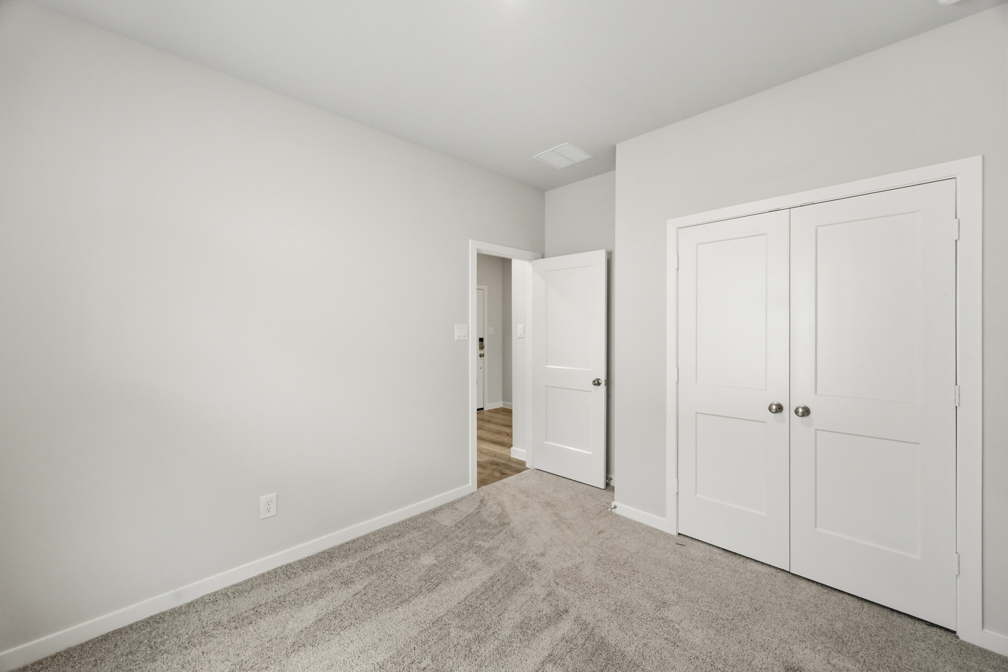 A hallway with white doors.