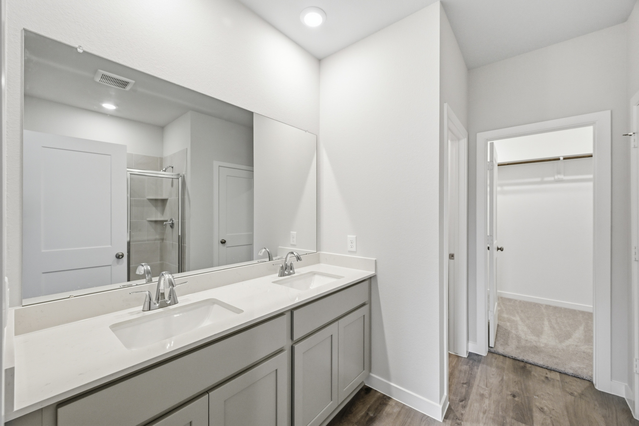 A bathroom with a large mirror.