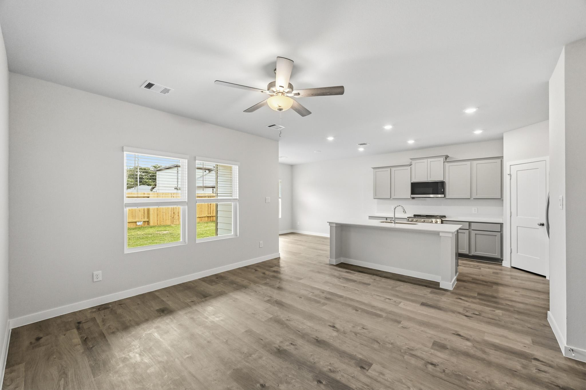A kitchen with a wood floor.