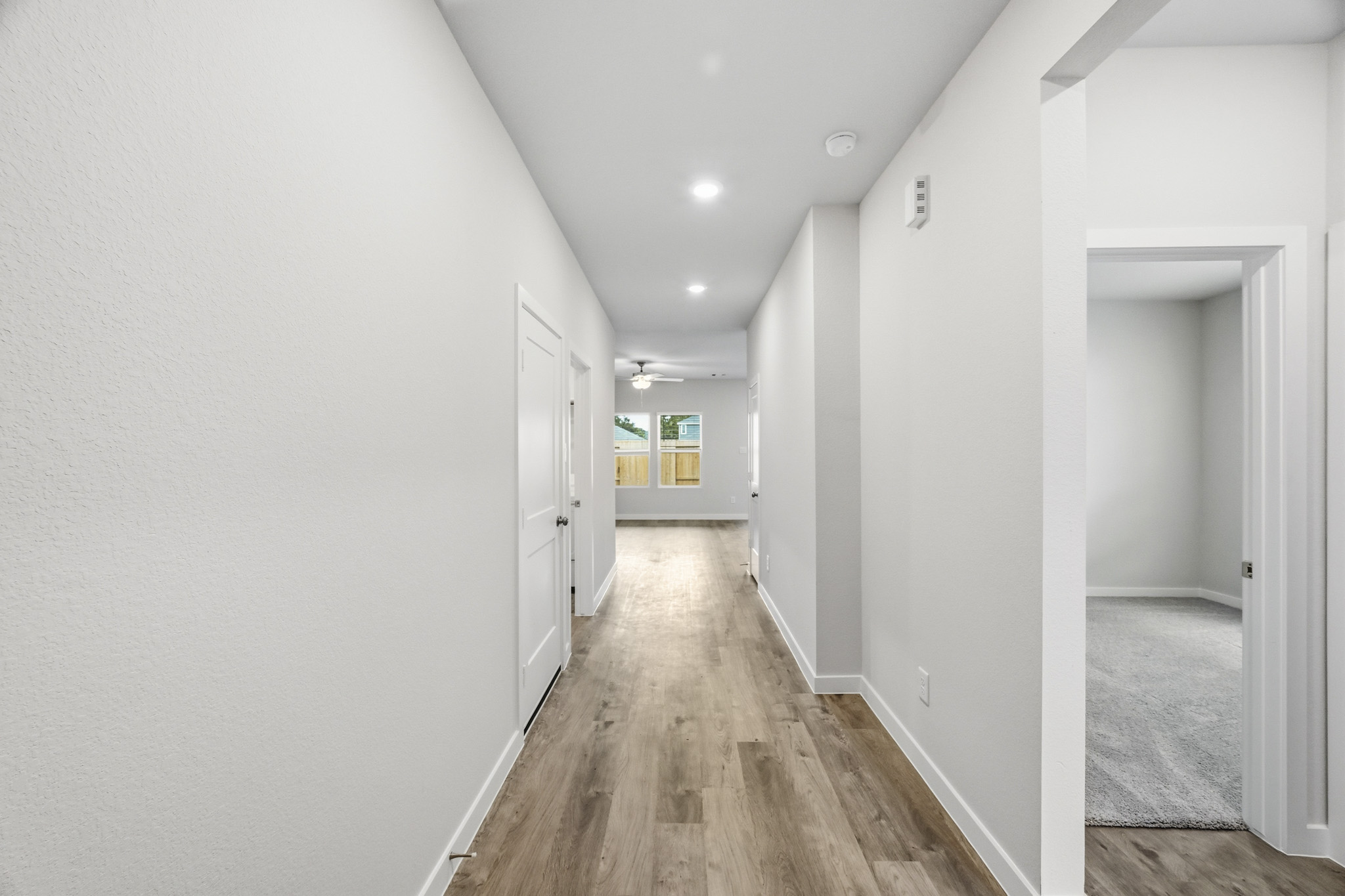 A hallway with white walls.