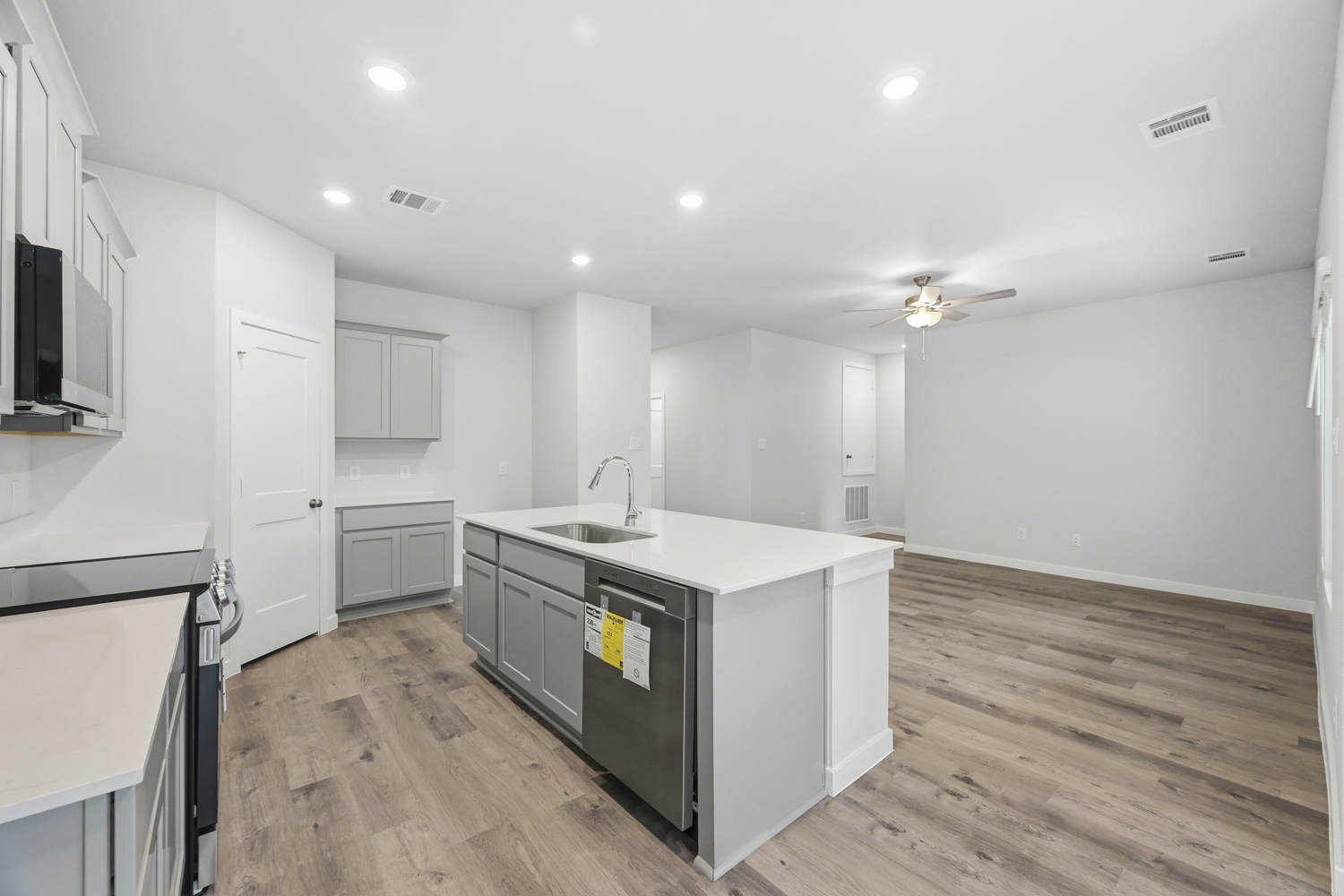 A kitchen with white cabinets.