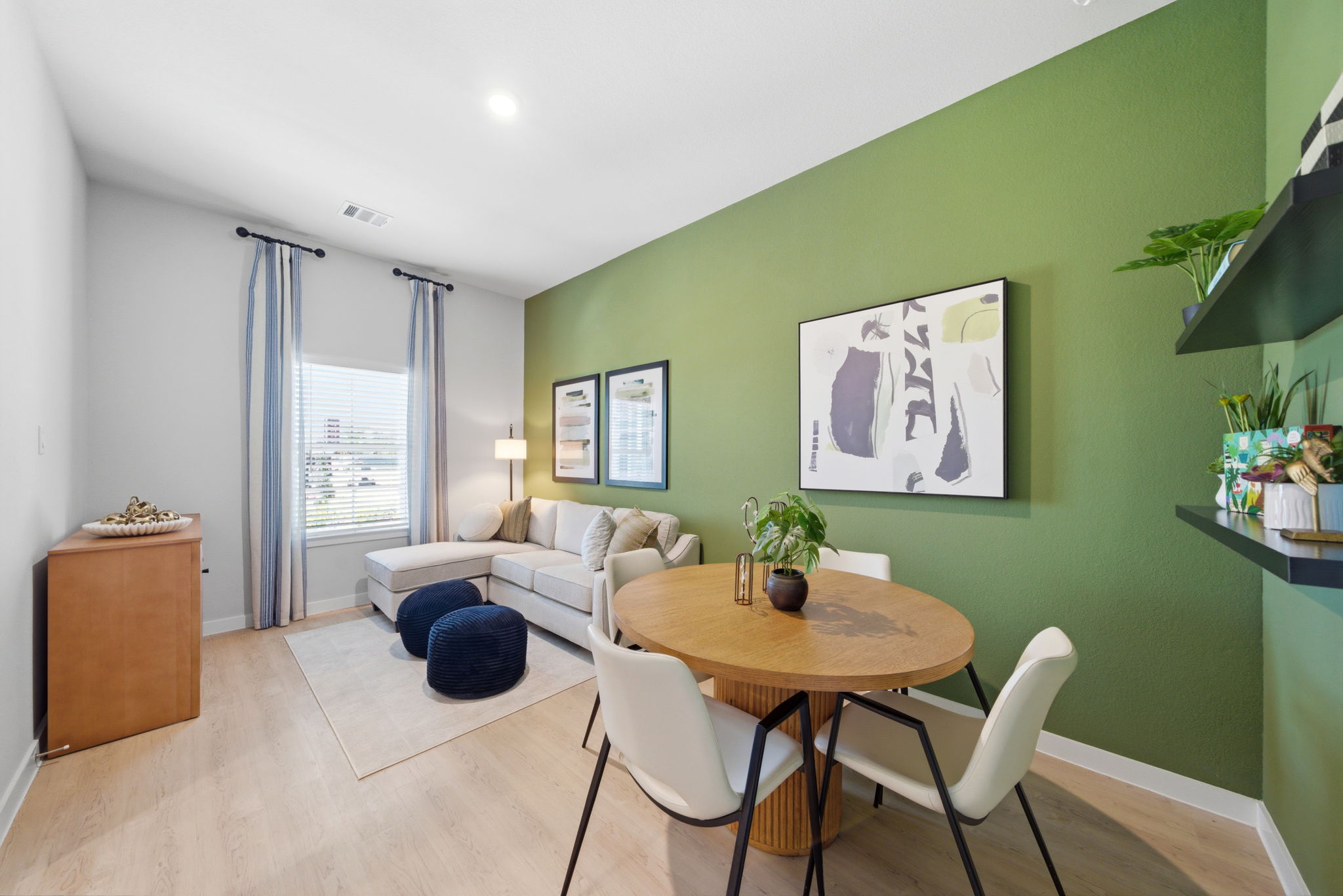 A living room with a table and chairs.