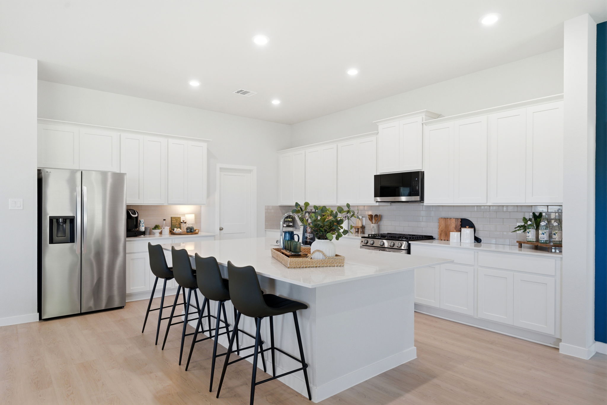 A kitchen with white cabinets.