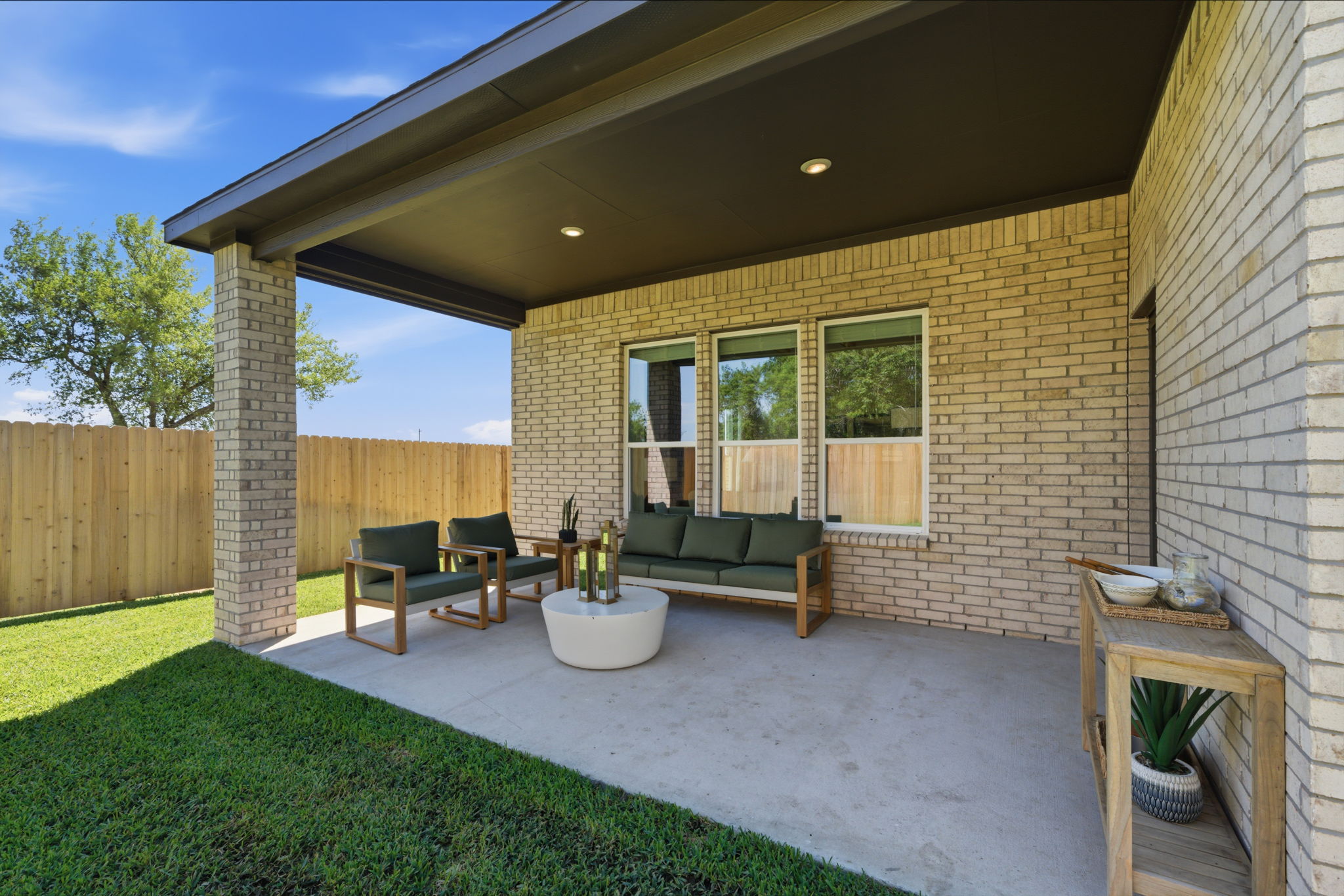 A backyard with a brick house.
