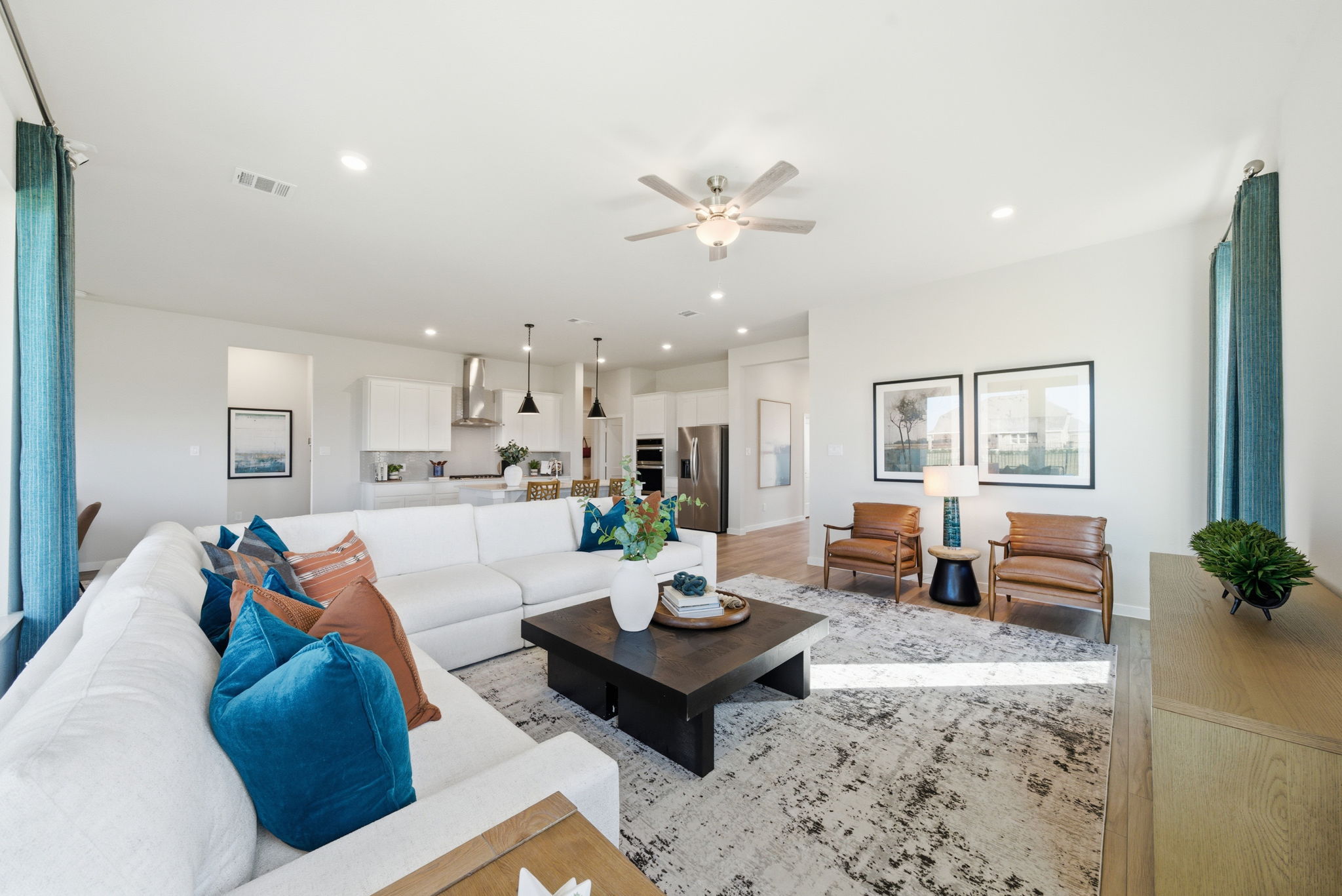 A living room with a large chandelier and a large white couch.