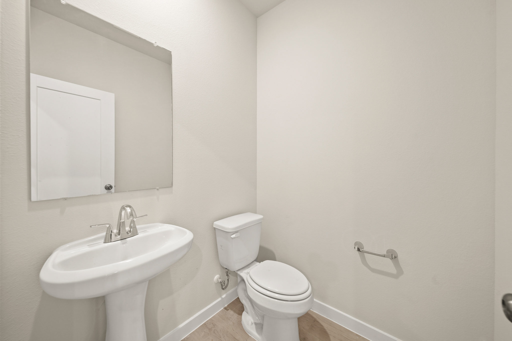 A bathroom with a toilet and sink.