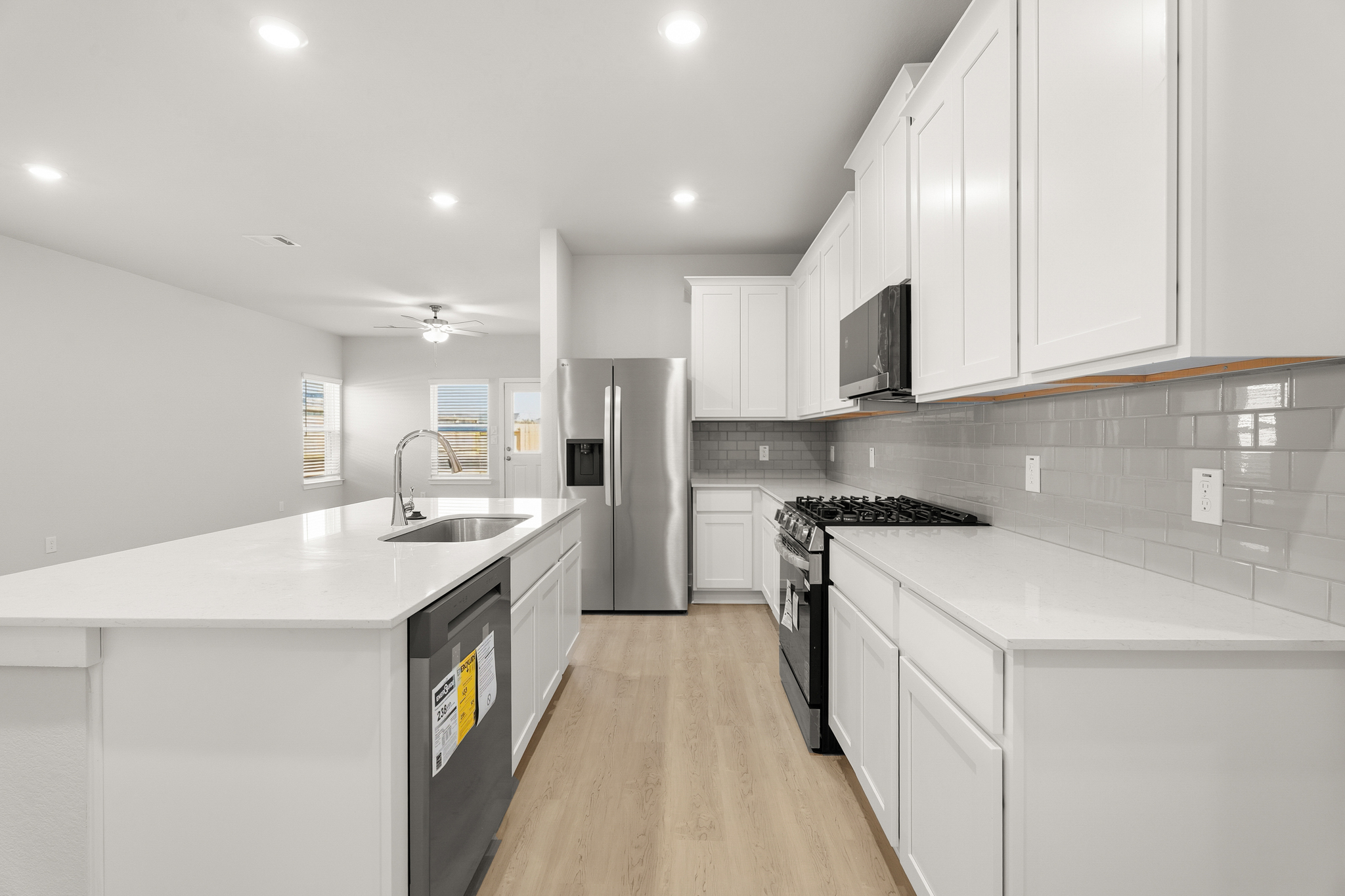 A kitchen with white cabinets.
