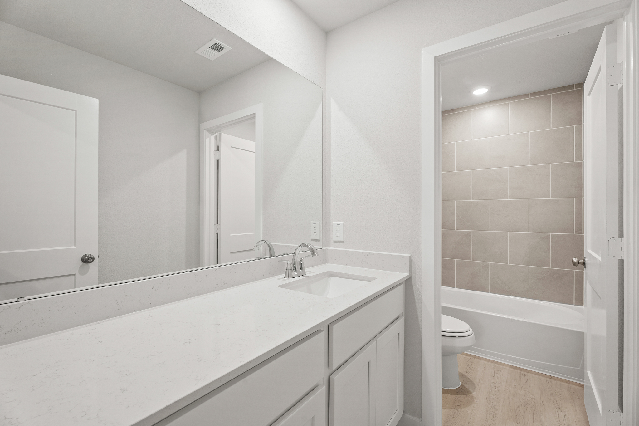 A bathroom with a tub sink and toilet.