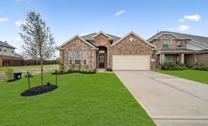 A large brick house with a driveway.