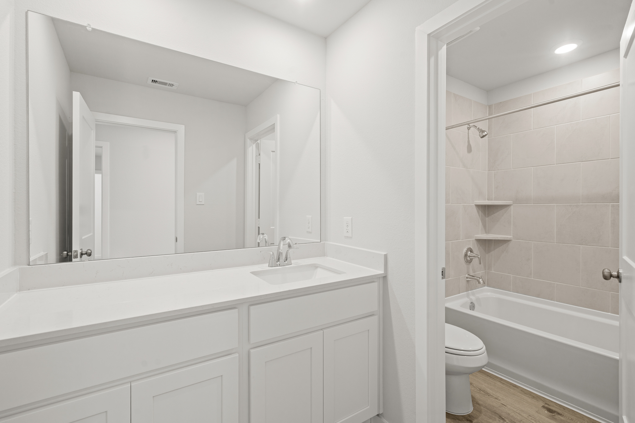 A bathroom with a tub sink and toilet.