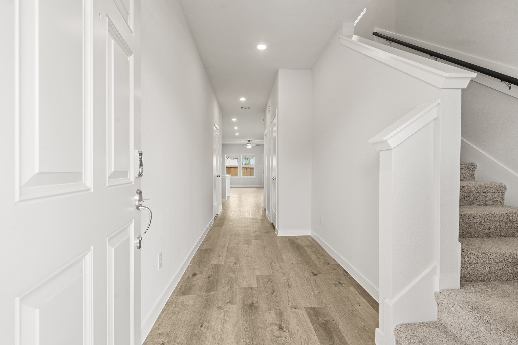 A hallway with white doors.